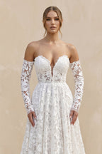 Robe de mariée ivoire trapèze en dentelle décolleté cœur manches longues - Harana